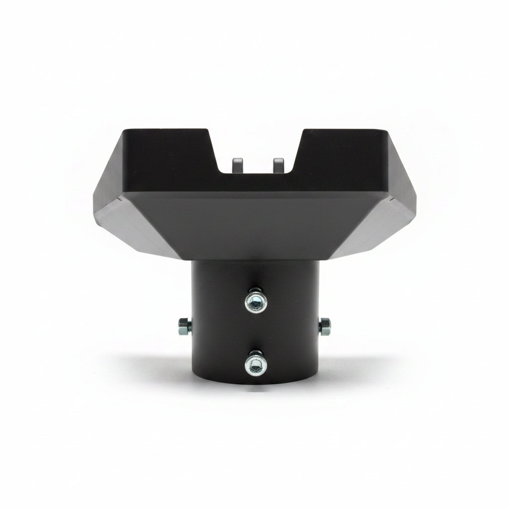 Black metal bracket with screws on a beige surface and textured gray background.   